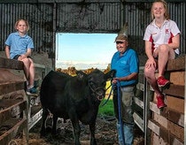 Noelle and Tayla Abbs with Peter Milton and Winston the 6th, the Angus Steer bought by the Abbs Family.