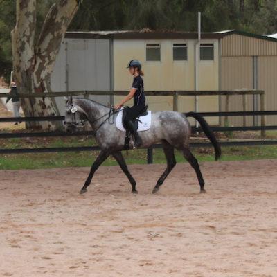 Jaime Baker warming up on her horse Imerandiel at the 2018 Interschool Championships